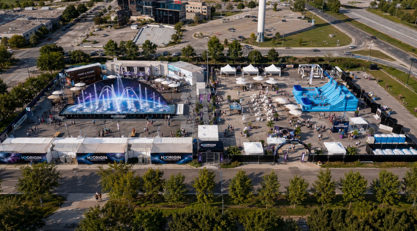 Immersive full-width wide shot of a futuristic aquatic park entrance with glowing blue bioluminescent structures and waterfalls
